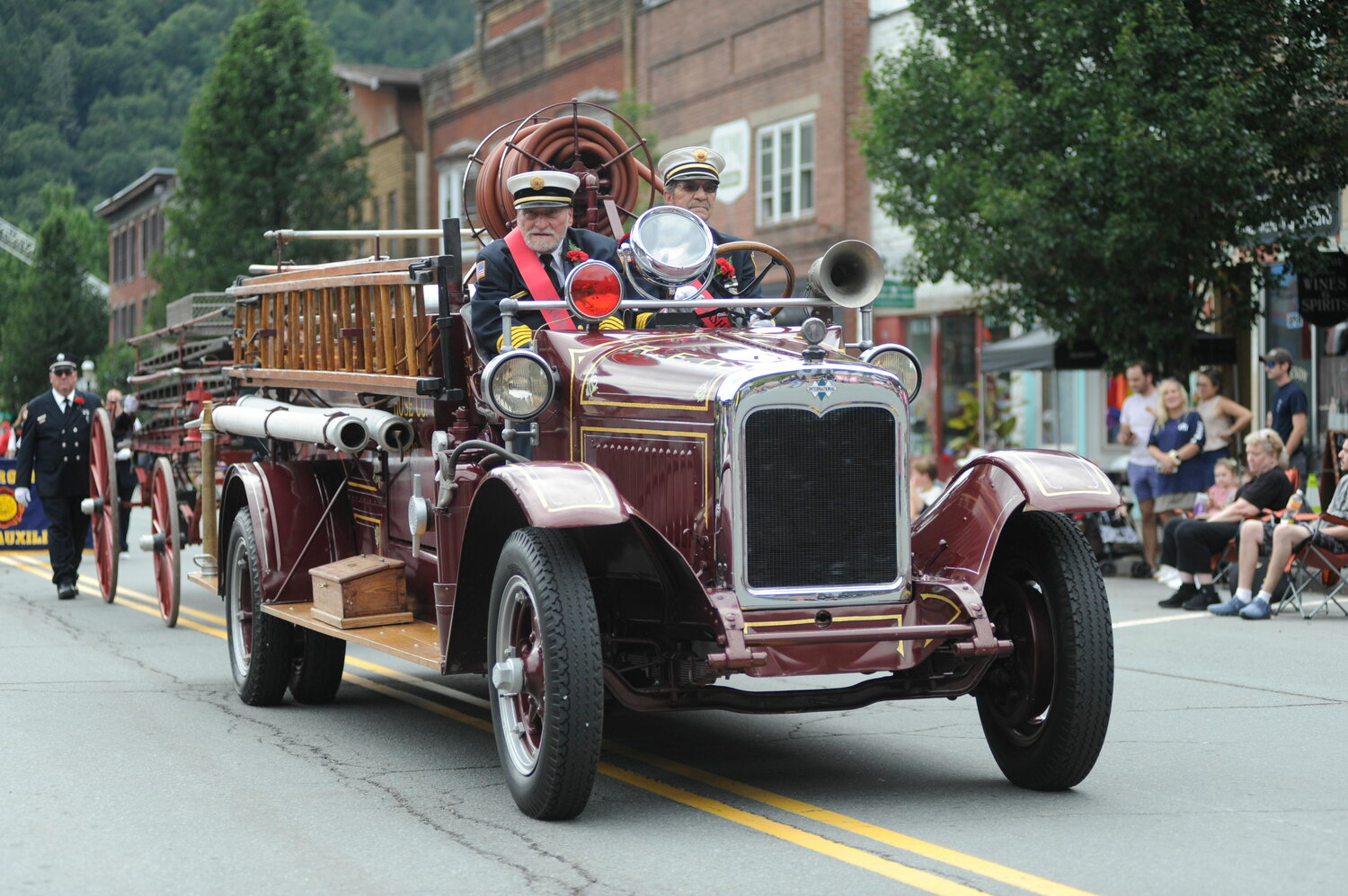 Roscoe’s ex chief Pete Passaro, catches a ride with ex-chief Steve Hecht, Sr. in the department’s faithfully restored 1929 International apparatus. Both former chiefs were honored as Grand Marshals. ..